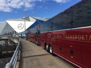 Red CIT Signature Transportation buses lined up in from of Merceds Benz Stadium
