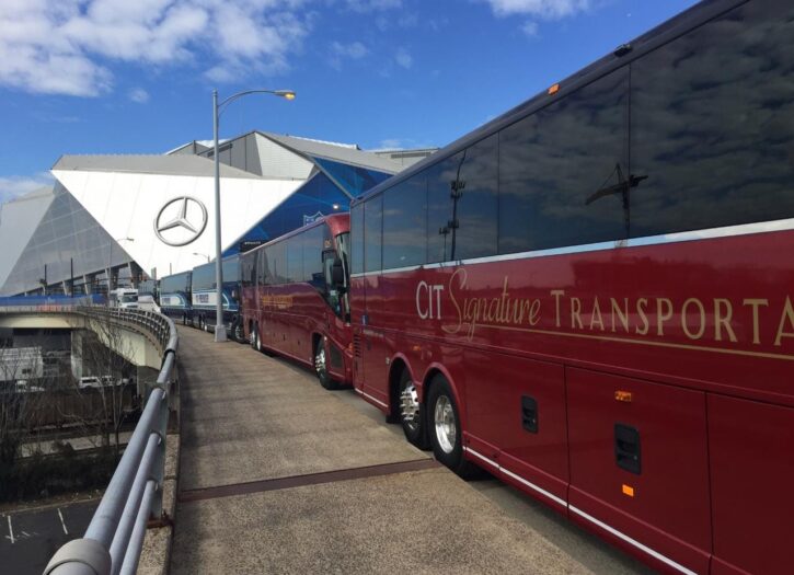 Red CIT Signature Transportation buses lined up in from of Merceds Benz Stadium